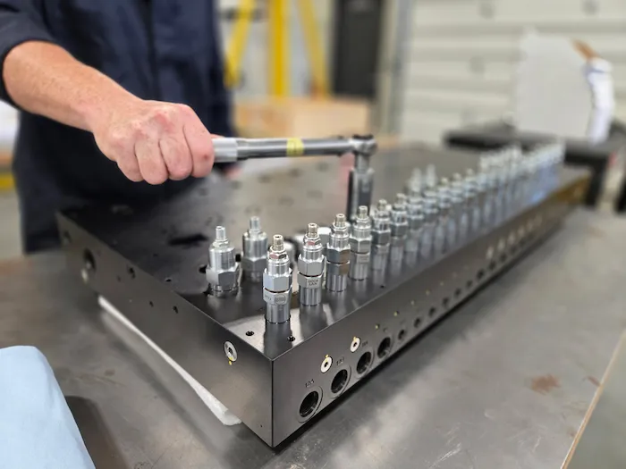 subsea hydraulic valve pack being assembled by wassoc technicican